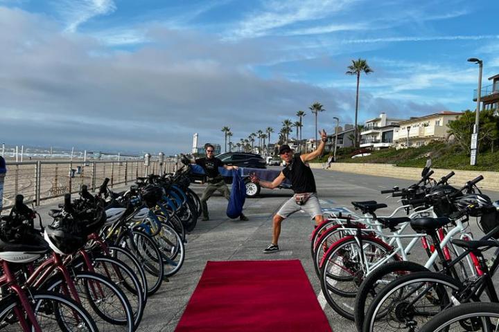 A group of bicycles by a red carpet on a boardwalk