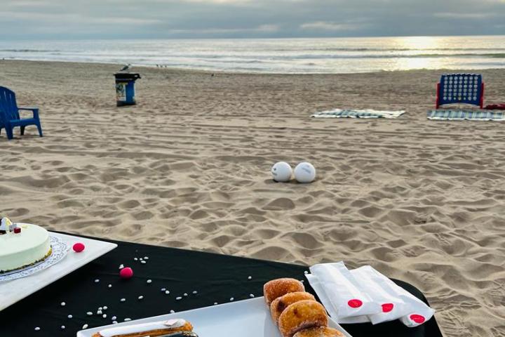desserts on a platter on a beach