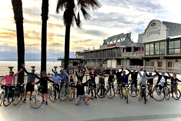a group of people on bikes by the ocean