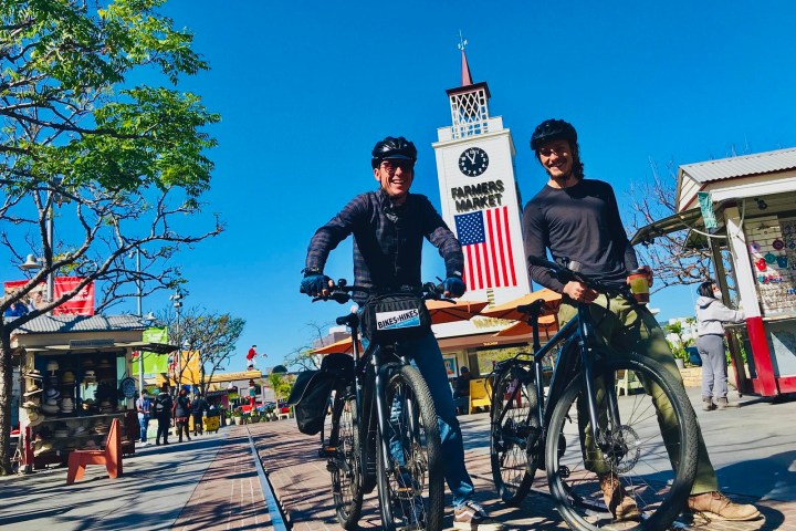 a group of people riding on the back of a bicycle