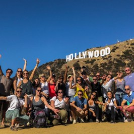 a group of people standing in front of a crowd posing for the camera
