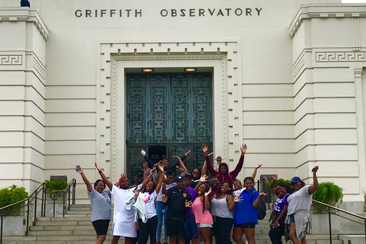 a group of people standing in front of a building