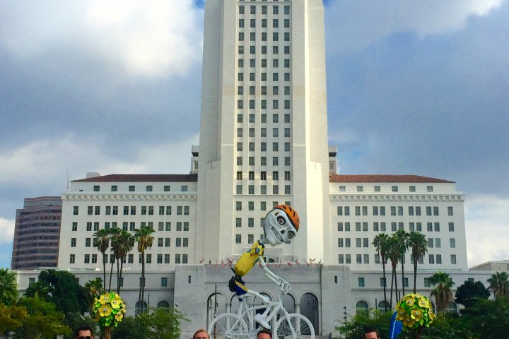 a group of people standing outside of city hall in downtown los angeles