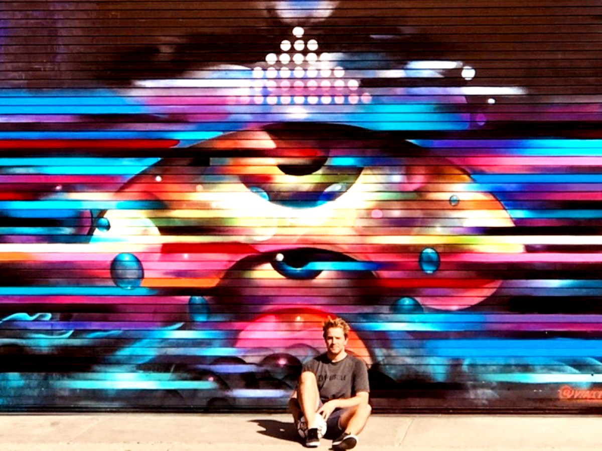 a person outside of a mural on a downtown la bike tour