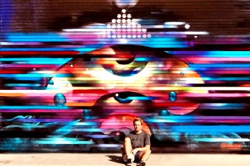 a person outside of a mural on a downtown la bike tour
