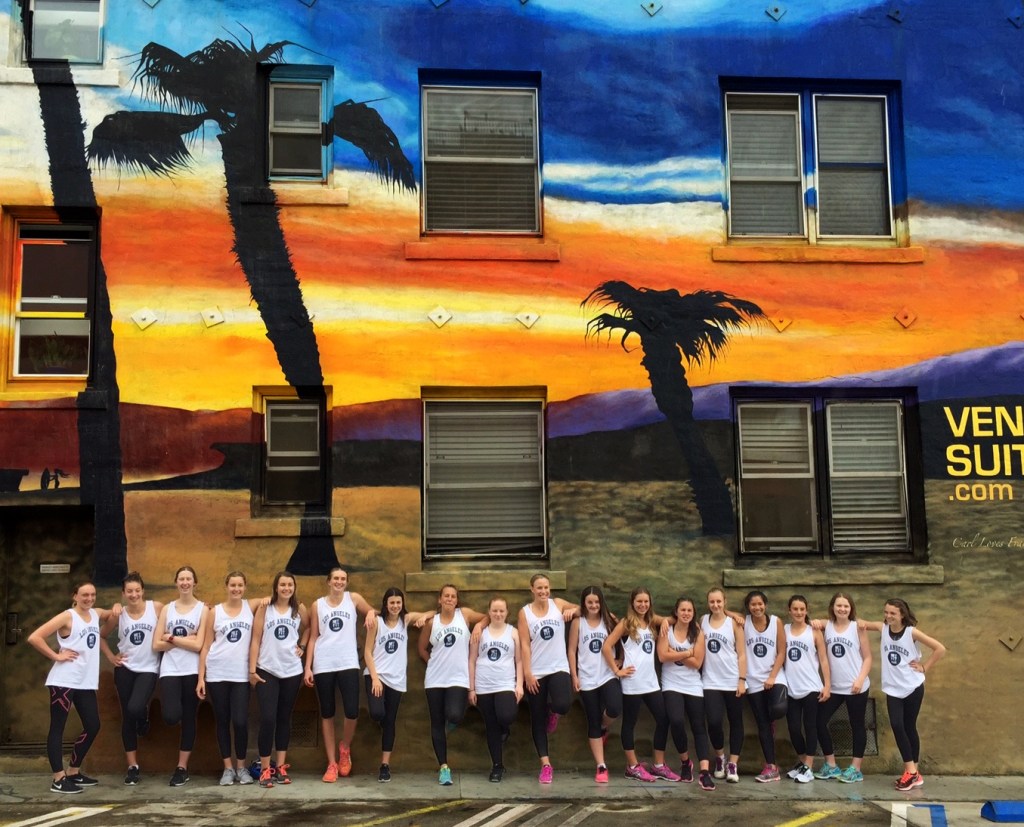 a group of people standing outside of a wall on a venice tour