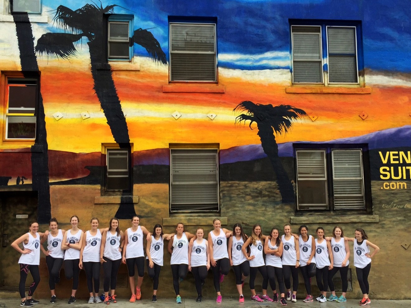 a group of people standing outside of a wall on a venice tour