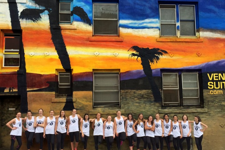 a group of people standing outside of a wall on a venice tour