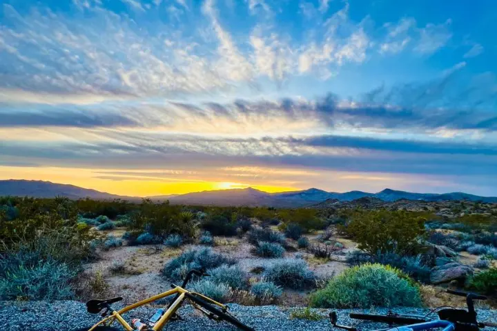 a bicycle leaning against a blue sky