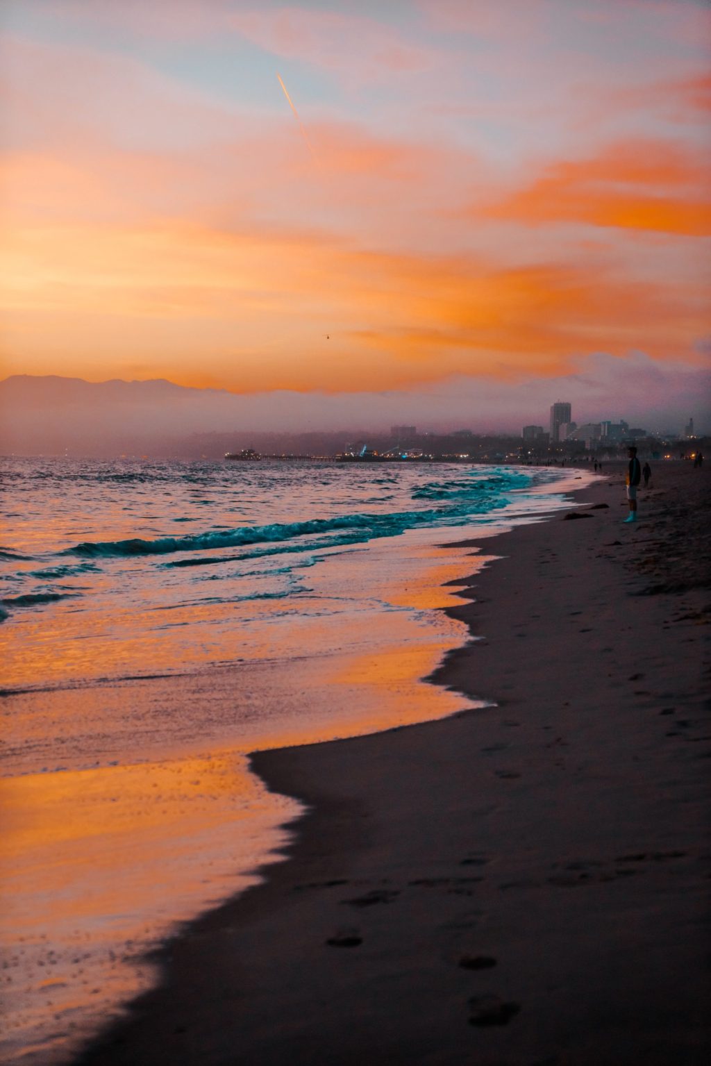 a sunset over a beach in santa monica on a los angeles tour