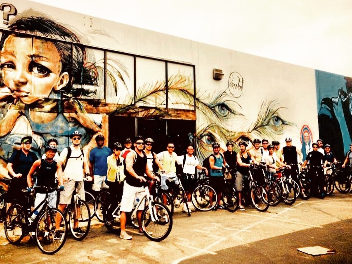 a group of people riding on the back of a bicycle