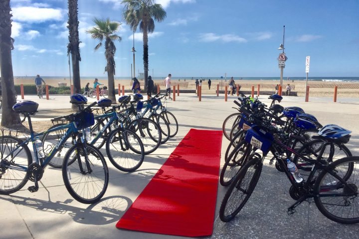 a group of people riding on the back of a bicycle