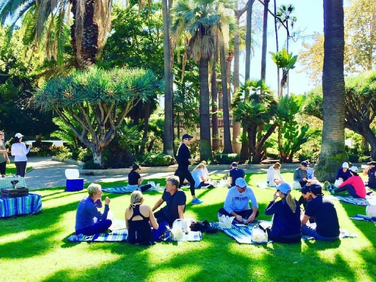 a group of people sitting at a park