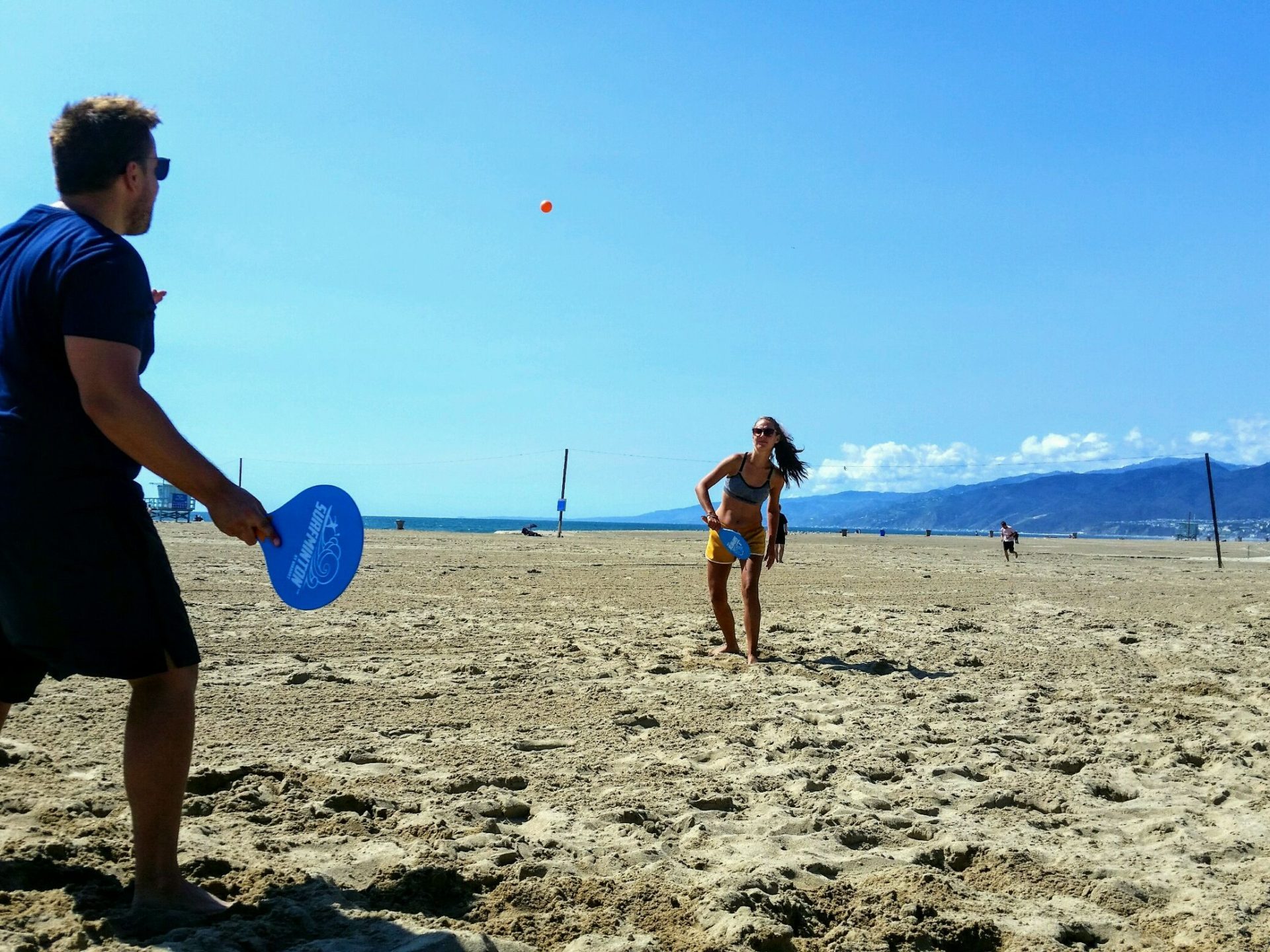 a man standing on top of a sandy beach