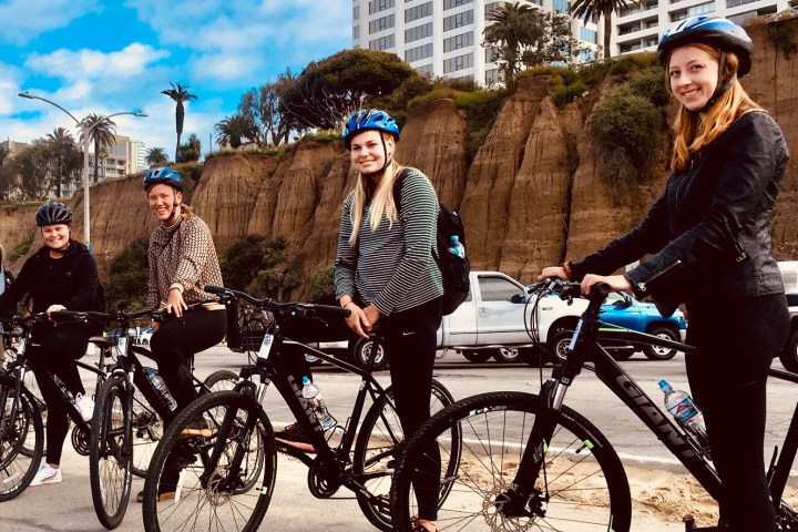 a group of people riding on the back of a bicycle