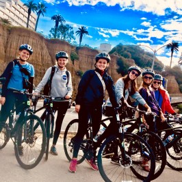 a group of people riding on the back of a bicycle