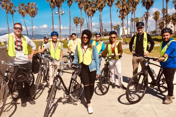 a group of people riding on the back of a bicycle
