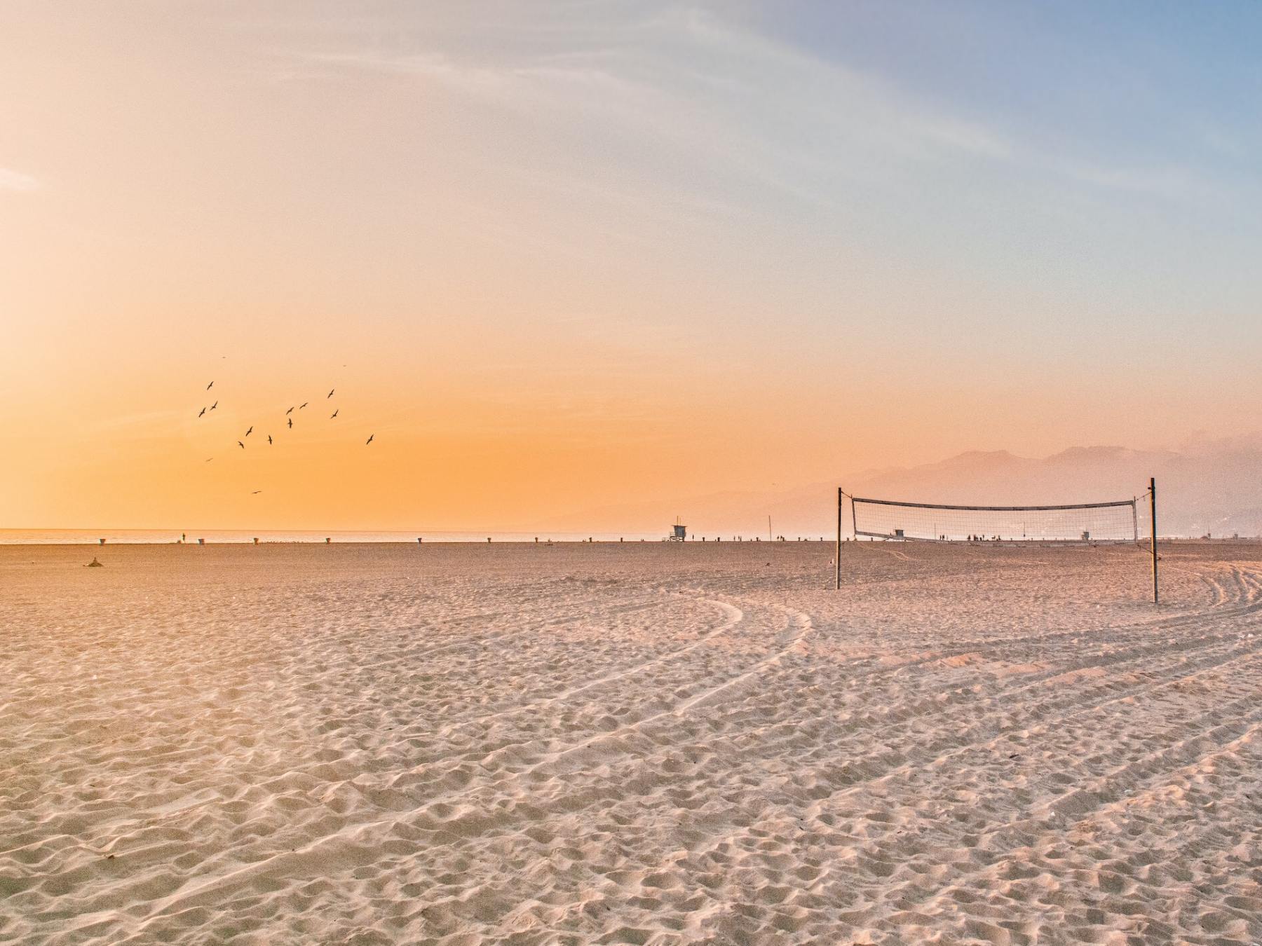 a sandy beach next to the ocean