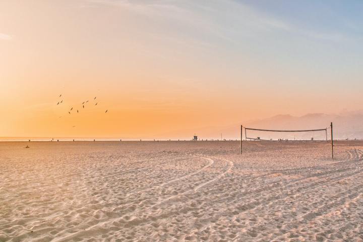 a sandy beach next to the ocean