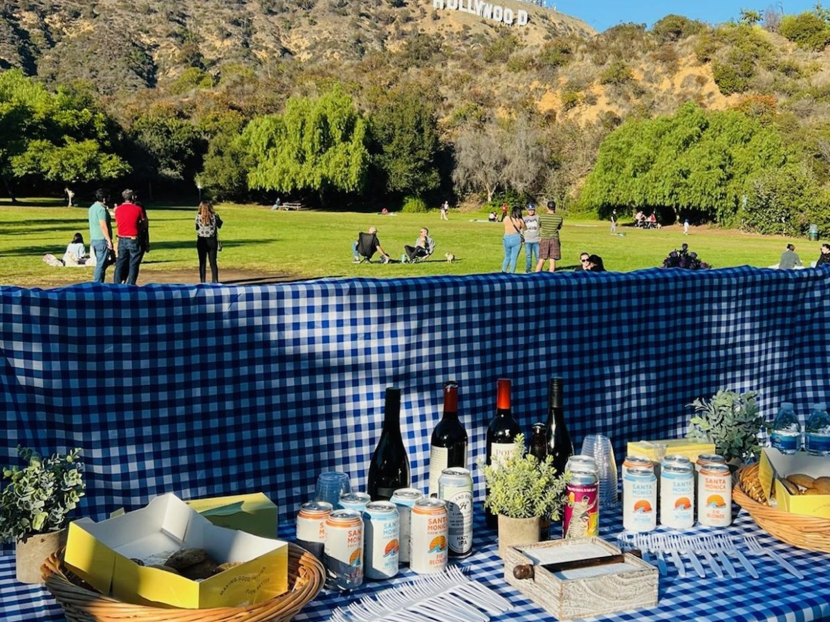 a group of people standing next to a fence