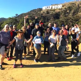 a group of people standing in front of a crowd posing for the camera