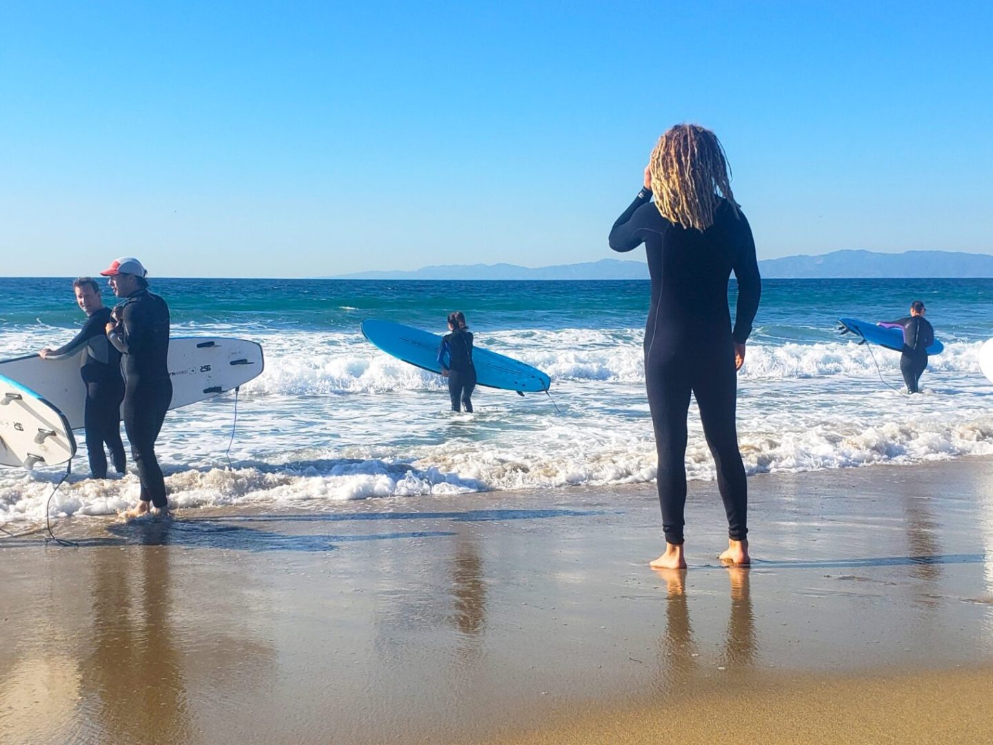 a group of people walking on a beach