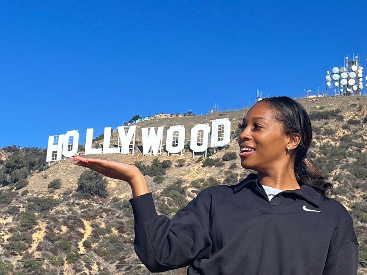 woman posting with the hollywood sign