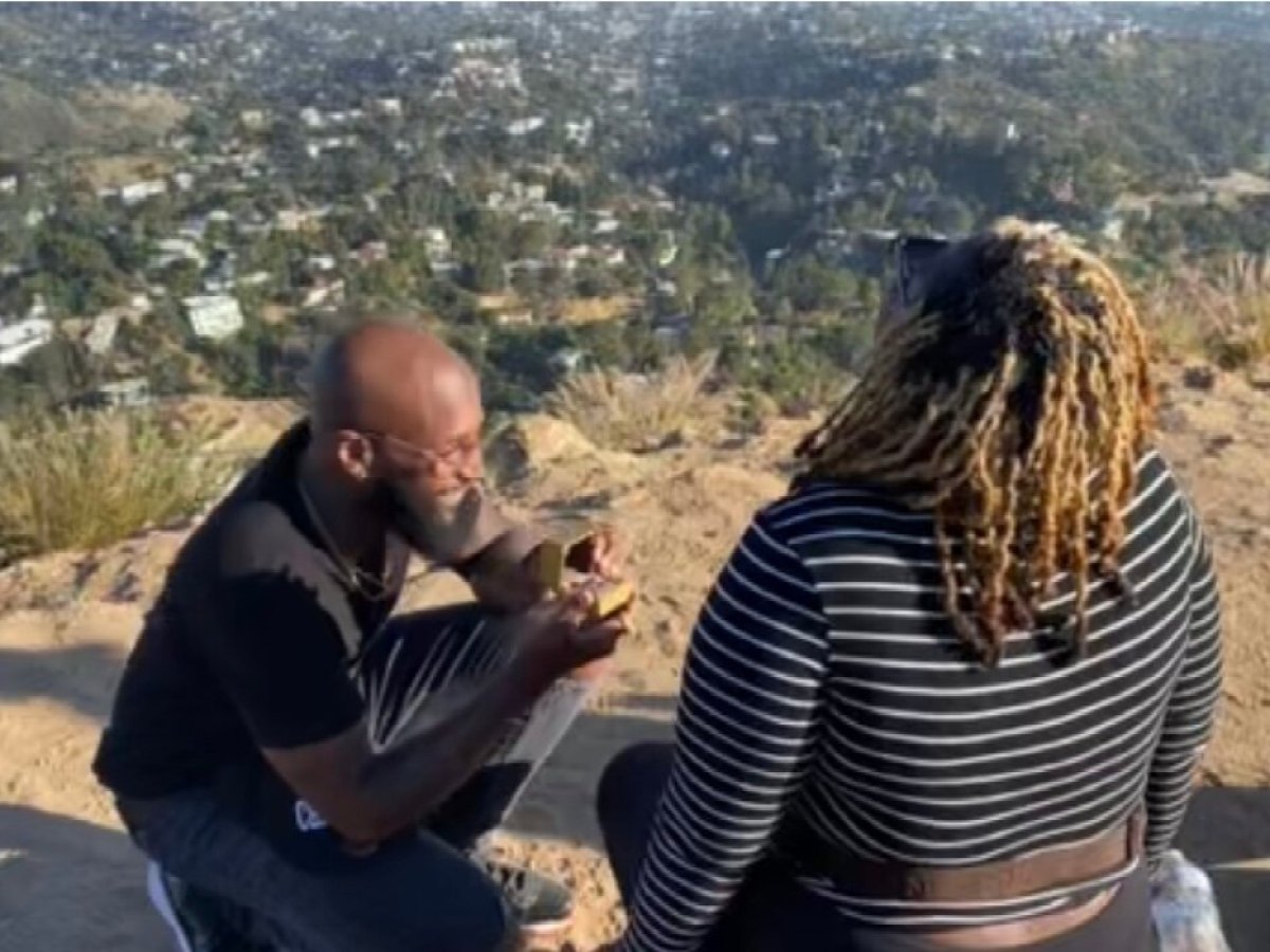 man proposing on top of hollywood sign hike