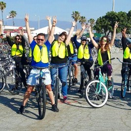 a group of people riding on the back of a bicycle