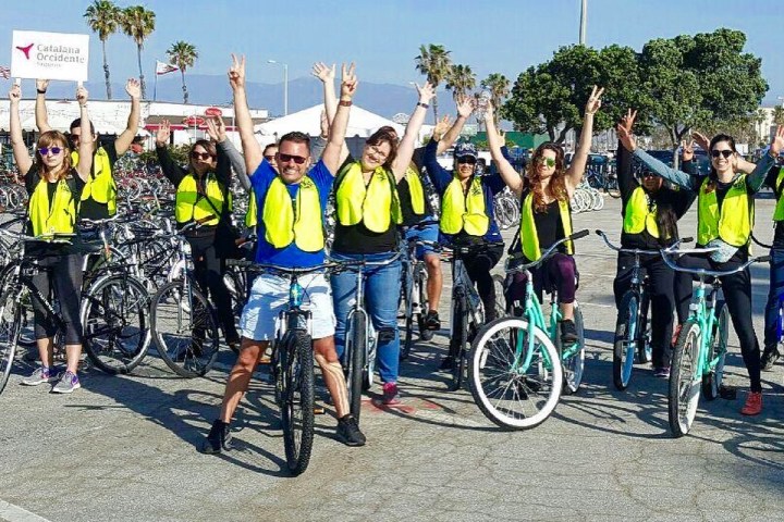 a group of people riding on the back of a bicycle