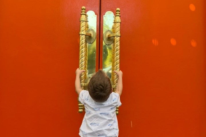 A child on Bikes and Hikes LA Palm Springs Door Tour looking at one of the doors