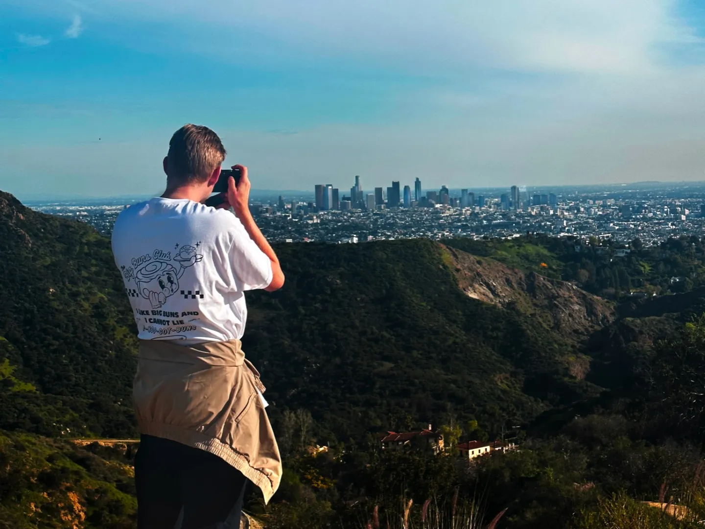 a man taking a photo of los angeles view