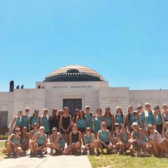 a group of people on a beach posing for the camera
