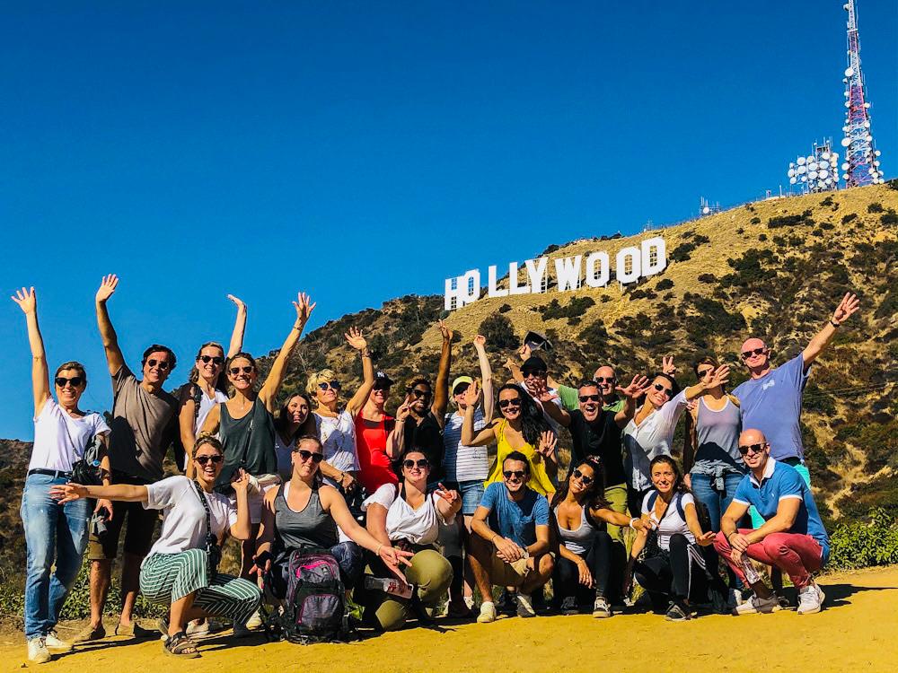 a group of people standing in front of a crowd posing for the camera