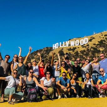 a group of people standing in front of a crowd posing for the camera