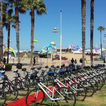 a group of people standing in front of a bicycle