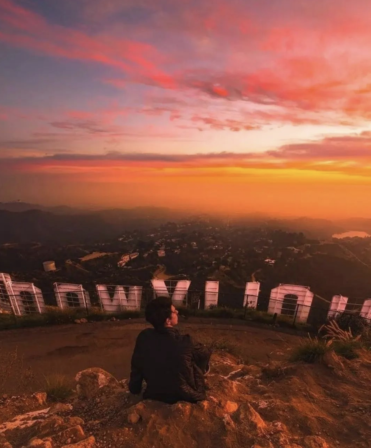 a man with a sunset in the background