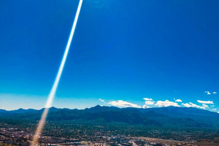 a sunburst in a blue sky on a hike tour