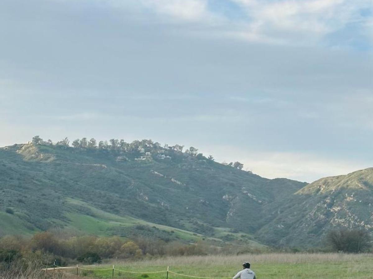 a man riding a bike down a bike trail in orange county on a southern california group tour