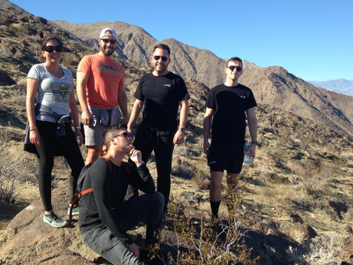 A group of hikers standing on top of a mountain on a palm springs group tour