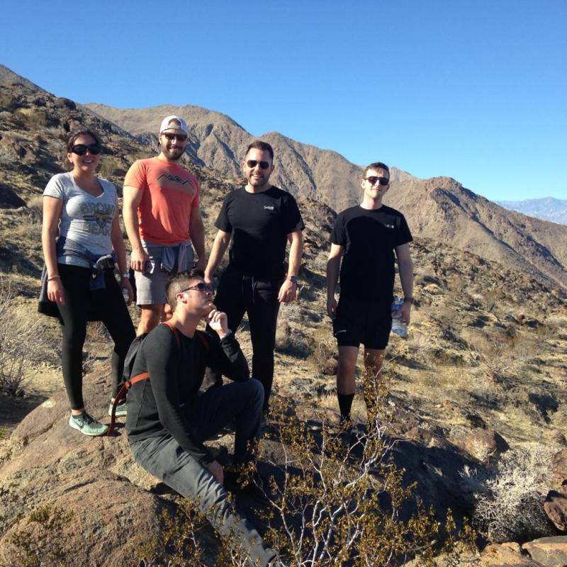 A group of hikers standing on top of a mountain on a palm springs group tour