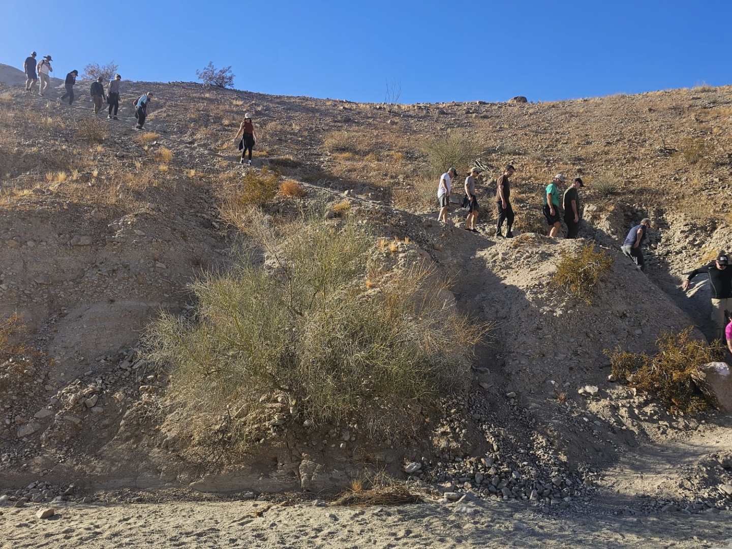 a group of people on a rocky hill