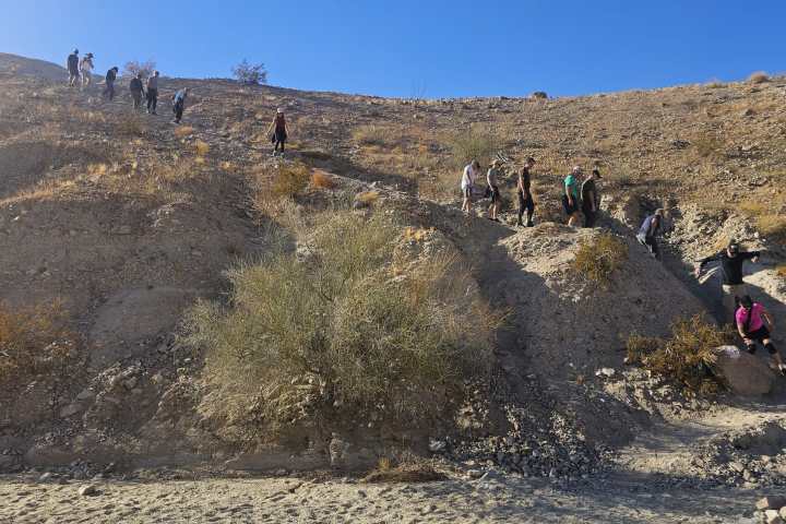 a group of people on a rocky hill