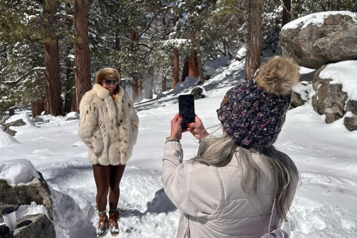 a couple of people that are standing in the snow
