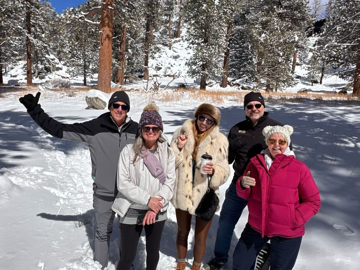 a group of people posing for a picture in the snow