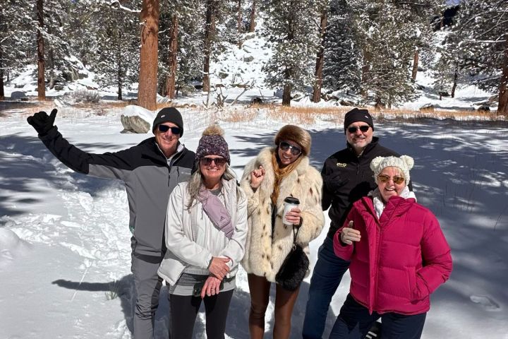 a group of people posing for a picture in the snow
