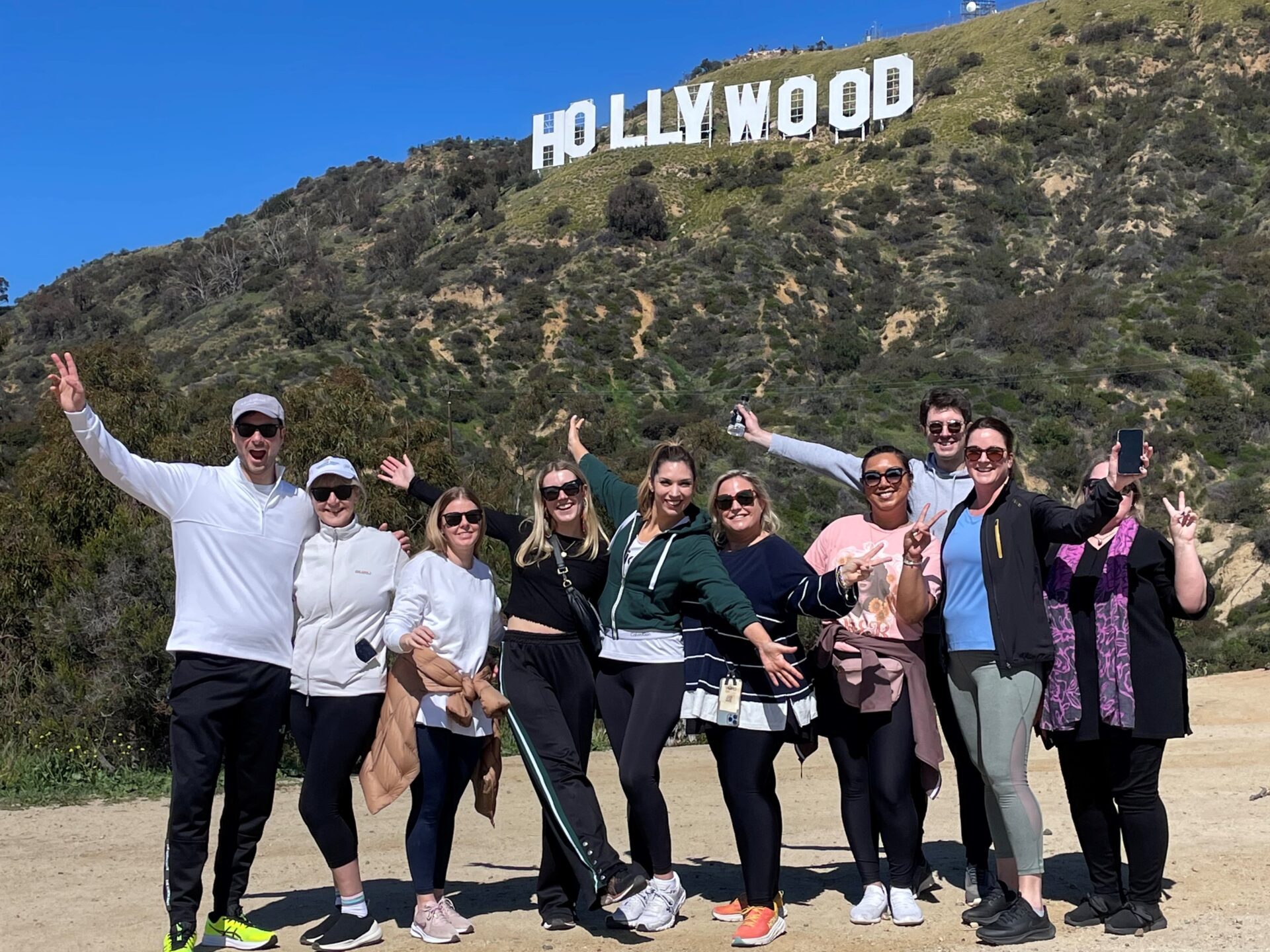 a group of people standing on top of a hill