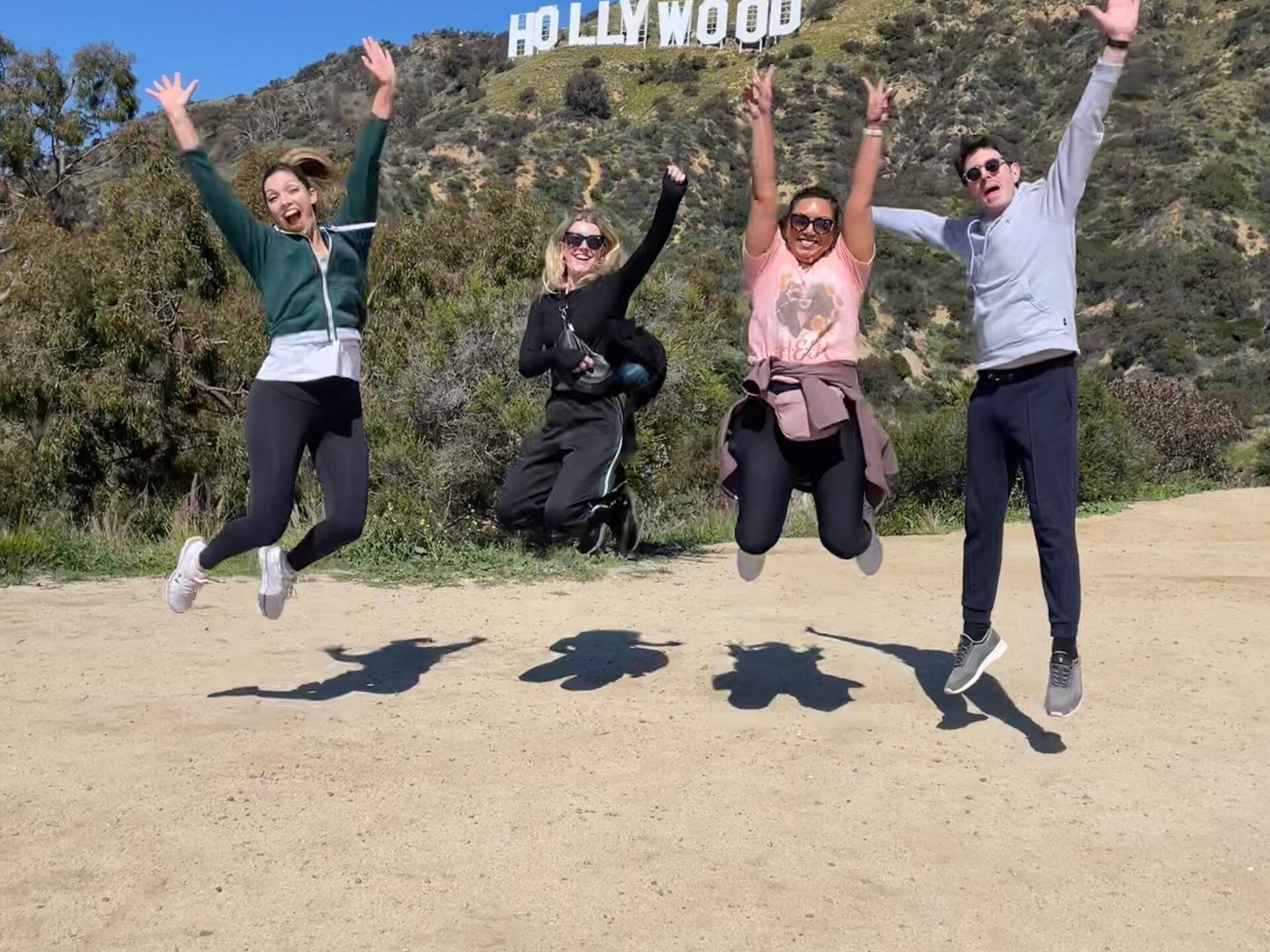a group of people flying kites on a beach