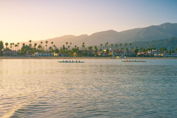 a large body of water with a mountain in the background