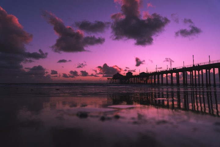 a train crossing a bridge over a body of water